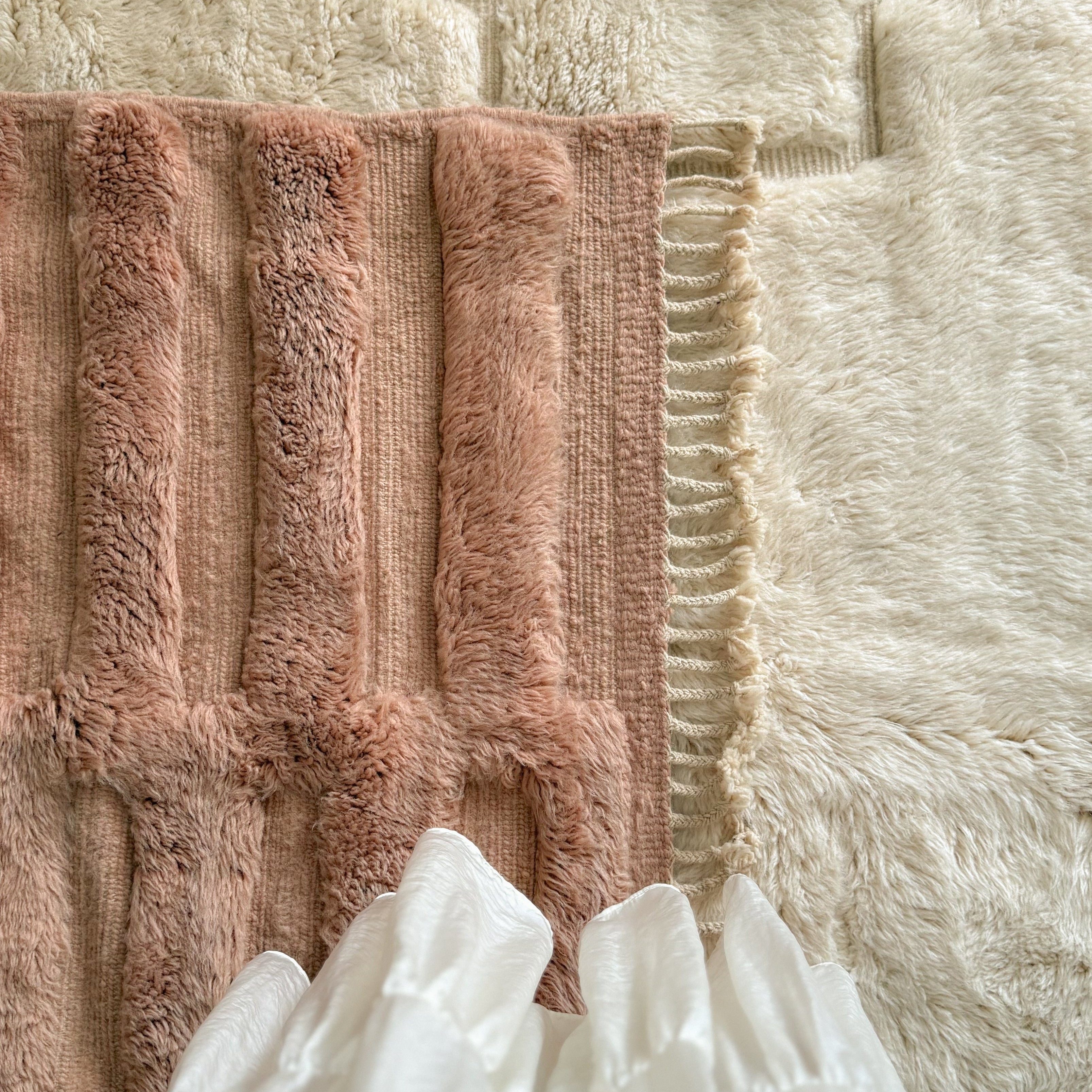 Detail of maroccan rug in soft terracotta colour.