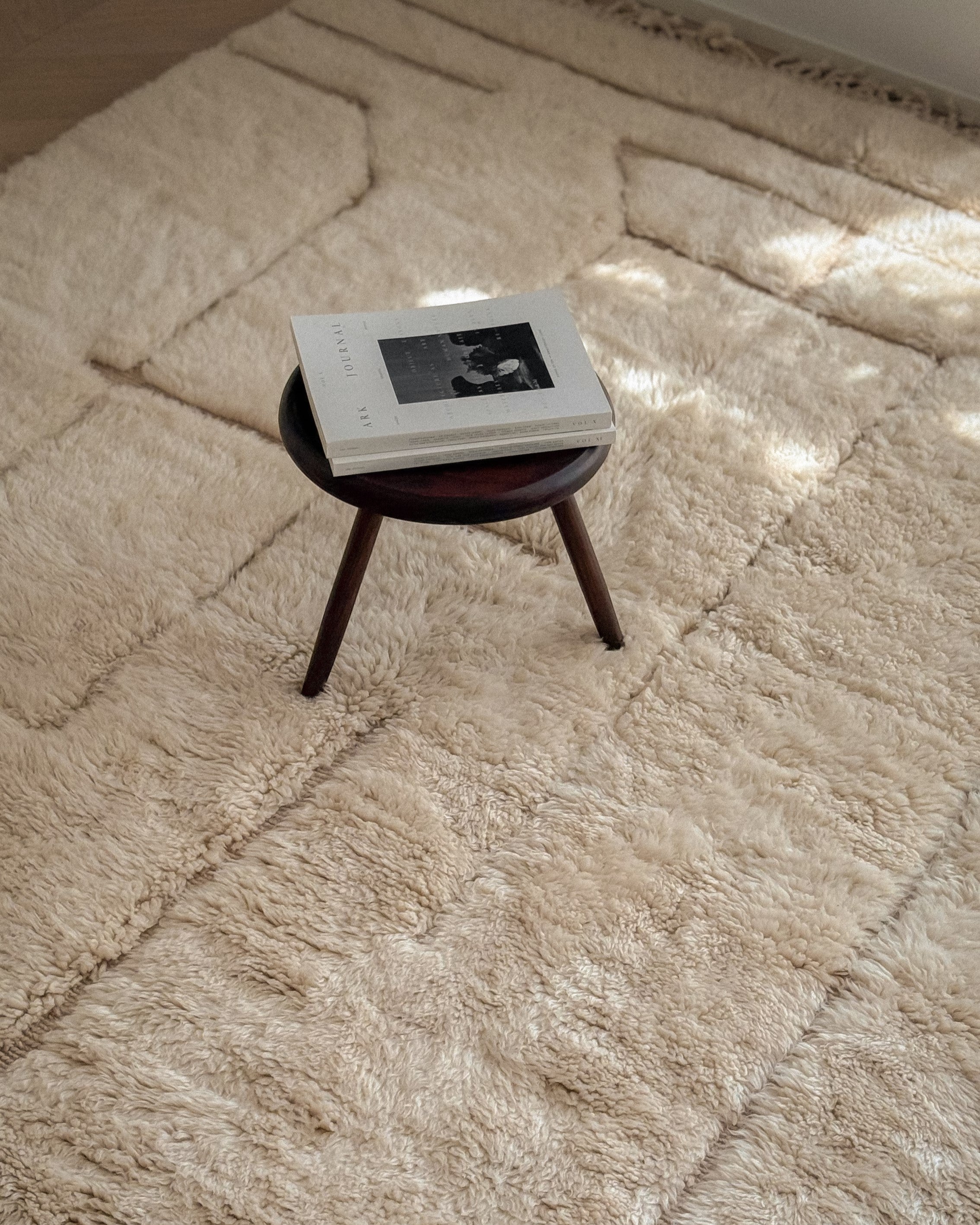 Beni Mrirt Moroccan wool rug No. 4 styled with wooden stool table in living room