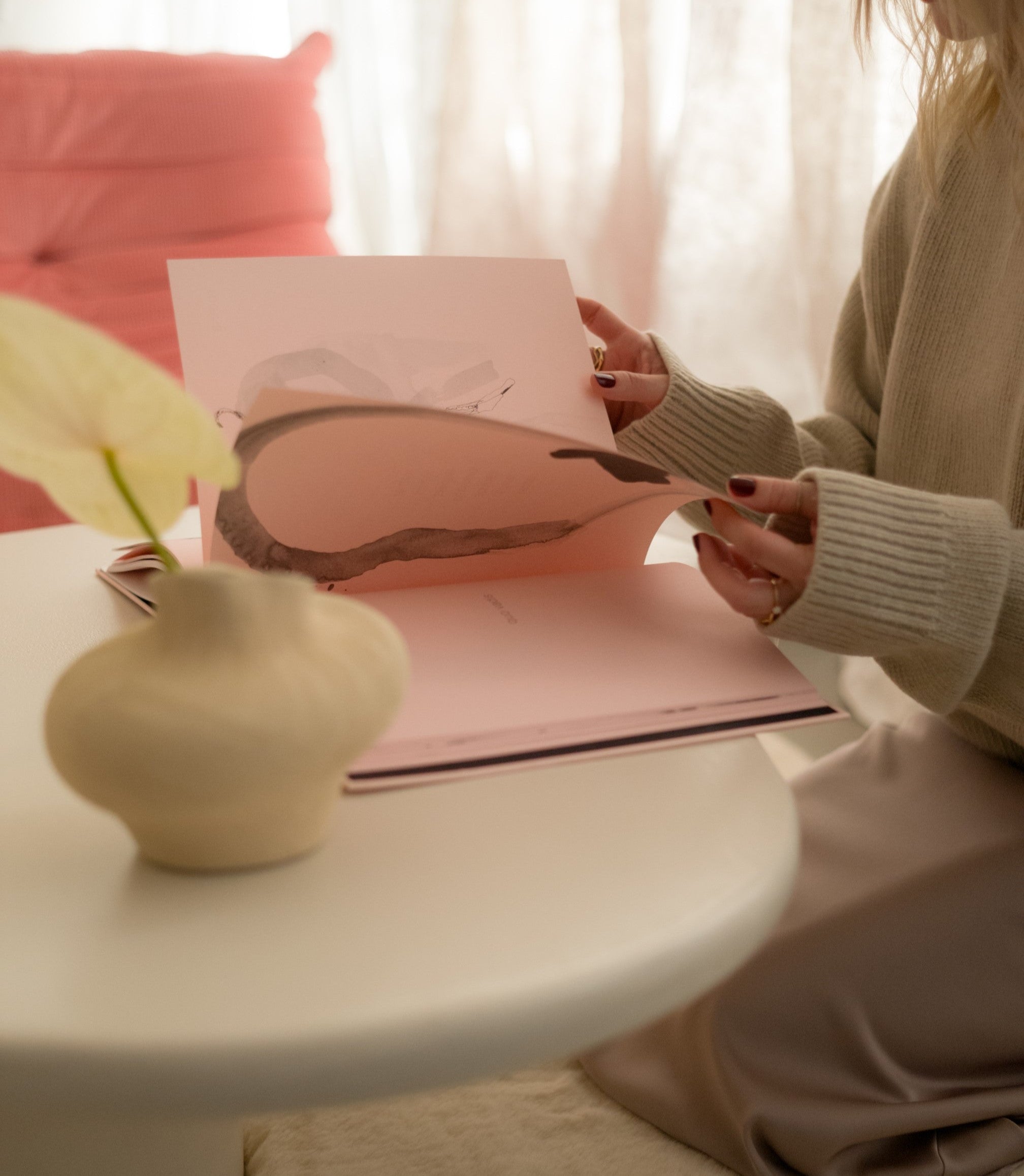 Detail of Kanso Organic coffee table in microcement with candle and ceramic decor