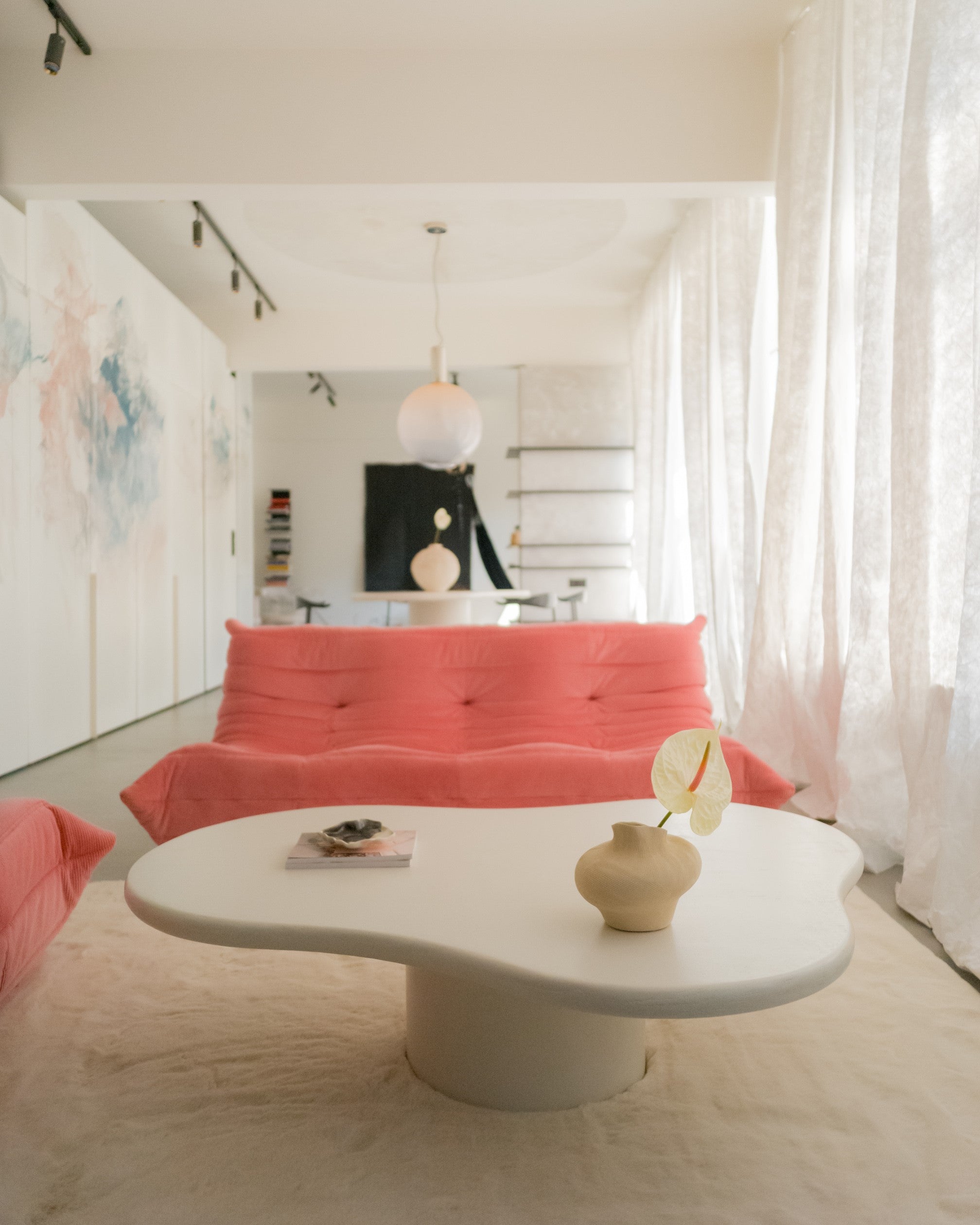 Kanso Organic microcement coffee table styled in living room with red sofa