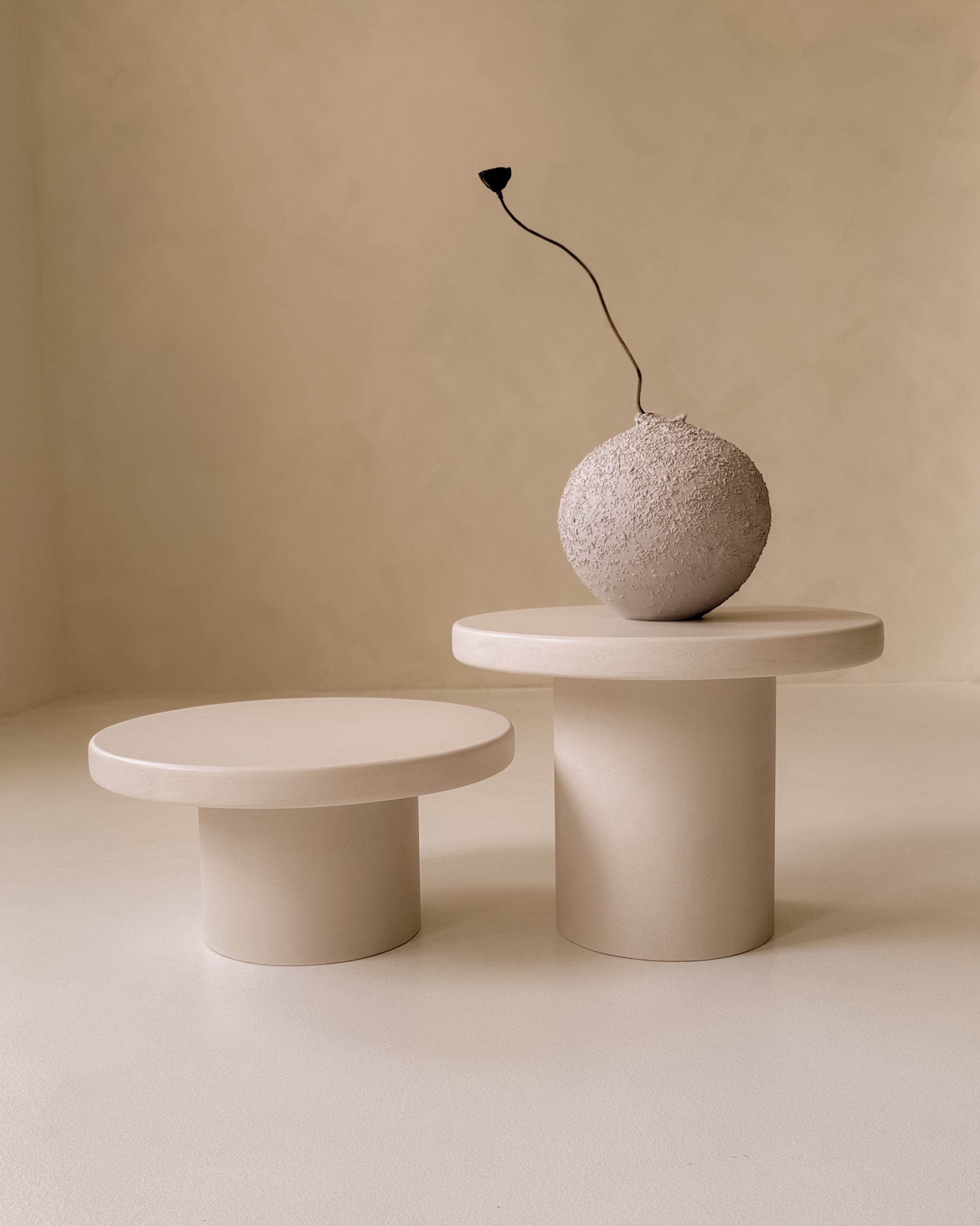 Kanso Round microcement coffee table set styled with sculptural vase