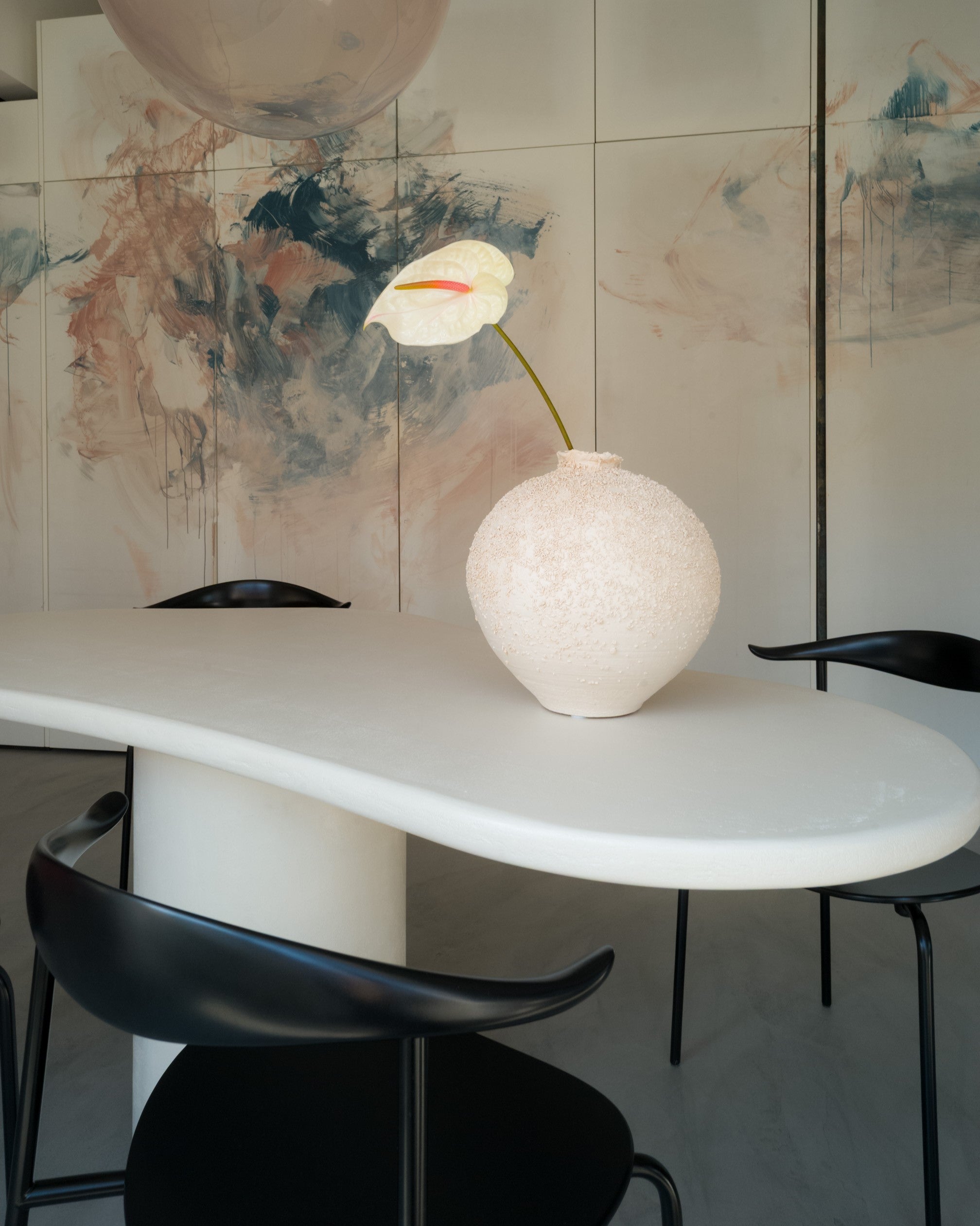 Top view of Kanso Organic dining table with asymmetrical microcement surface