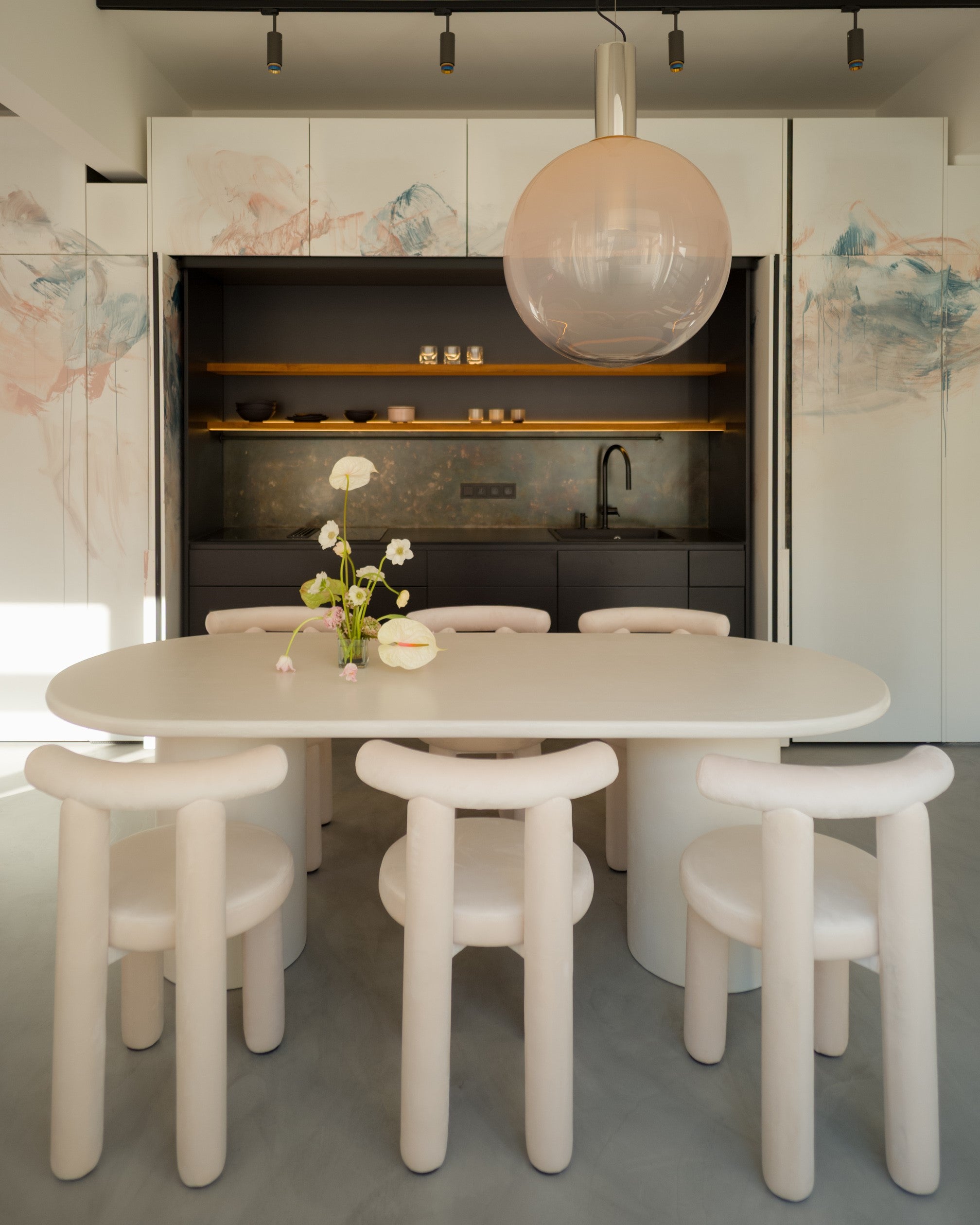 Kanso Oval microcement dining table with pendant light and matching chairs