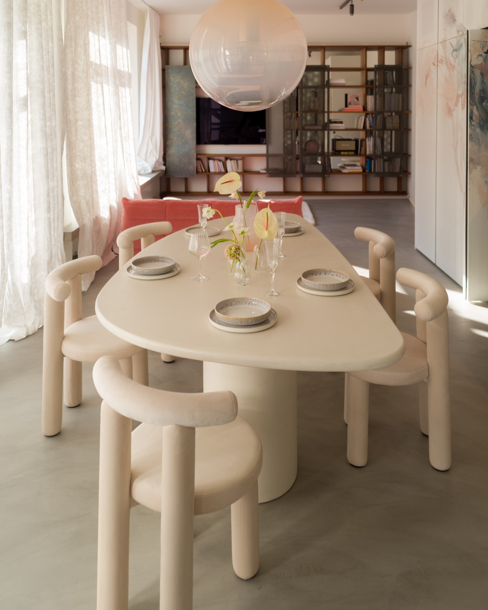 Kanso Wing dining table in microcement finish with matching chairs