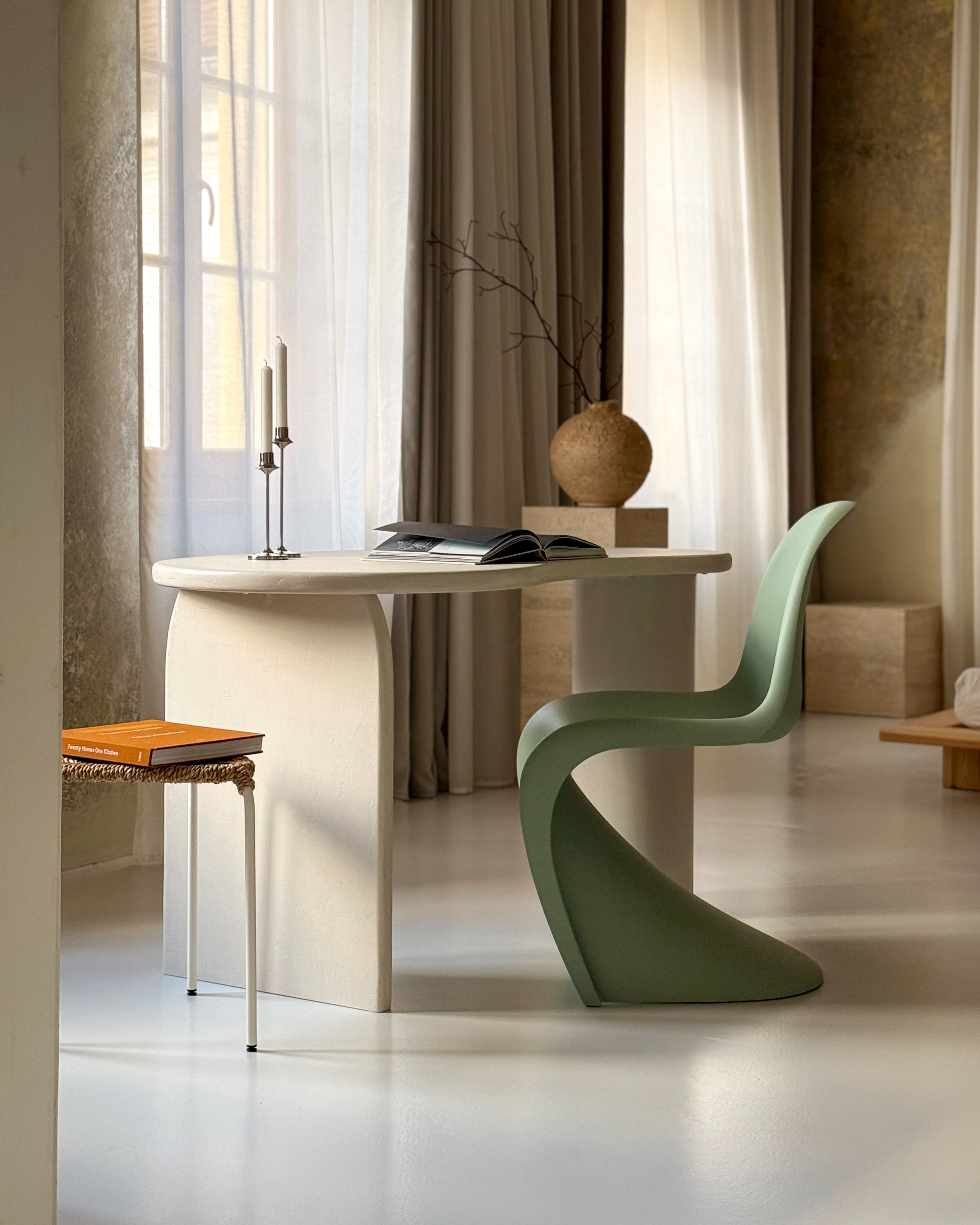 Kanso organic microcement work desk styled with chair and decorative objects in living space