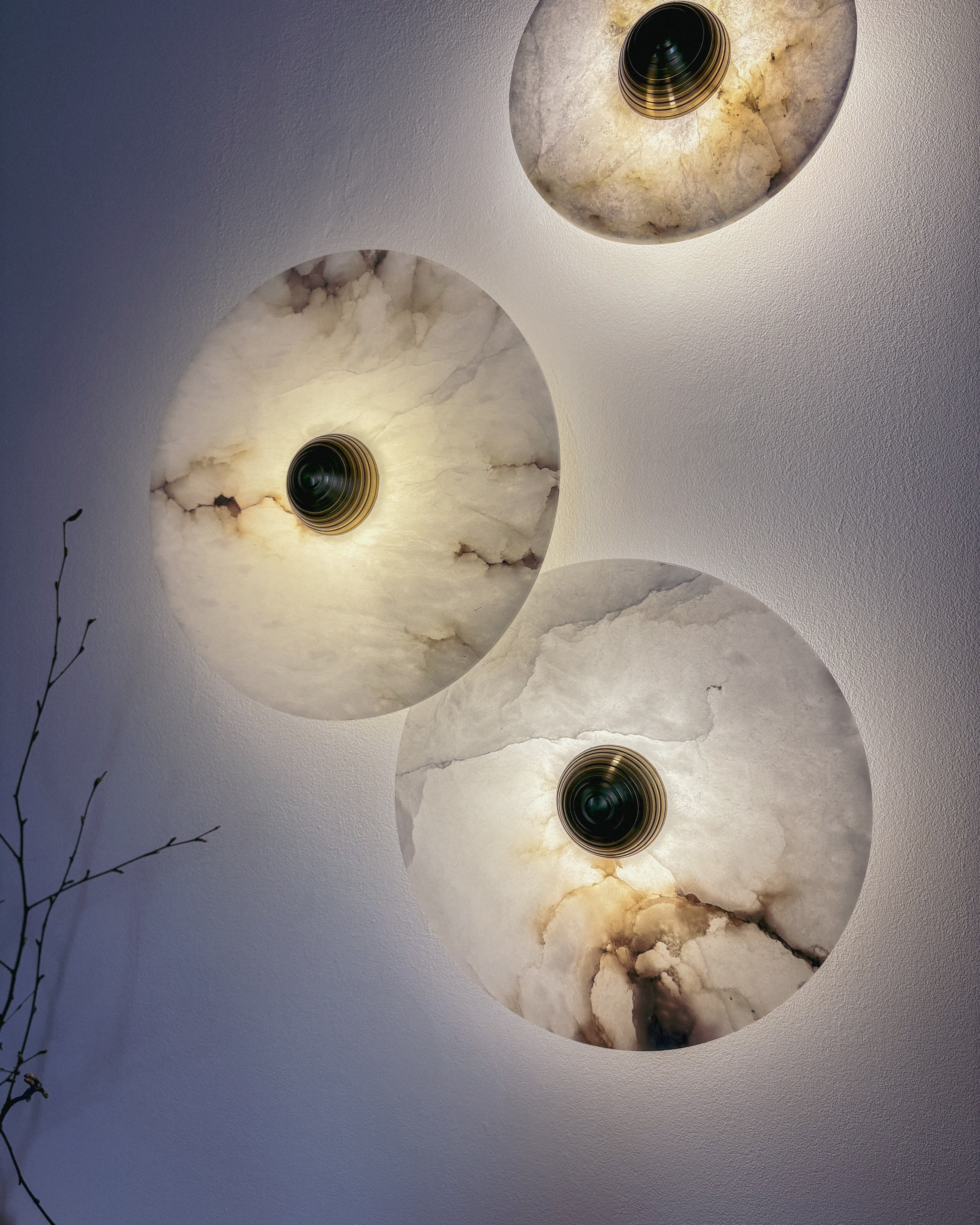 Marble wall sconce with natural stone patterns, warm glow in dark interior