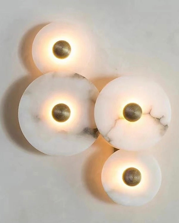 Set of marble wall lights with brass accents, glowing ambient light