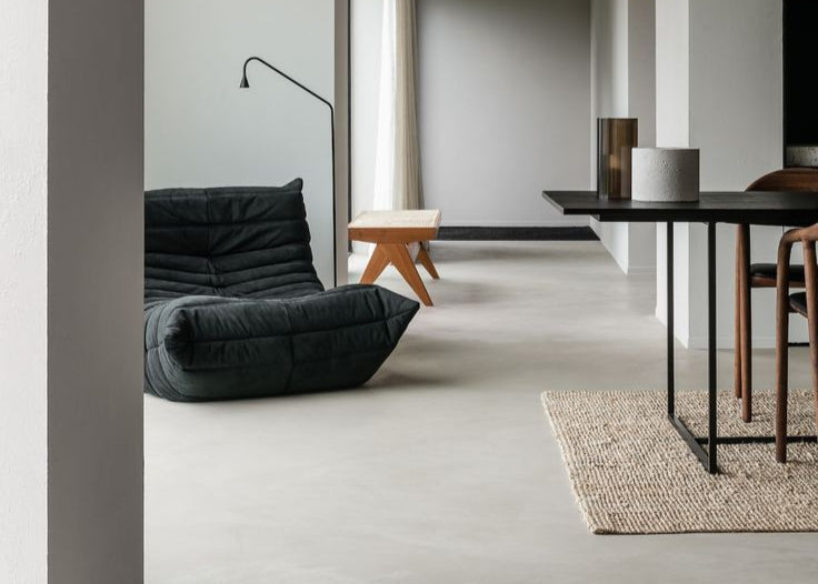 Microcement floor in soft grey colour in modern interior.