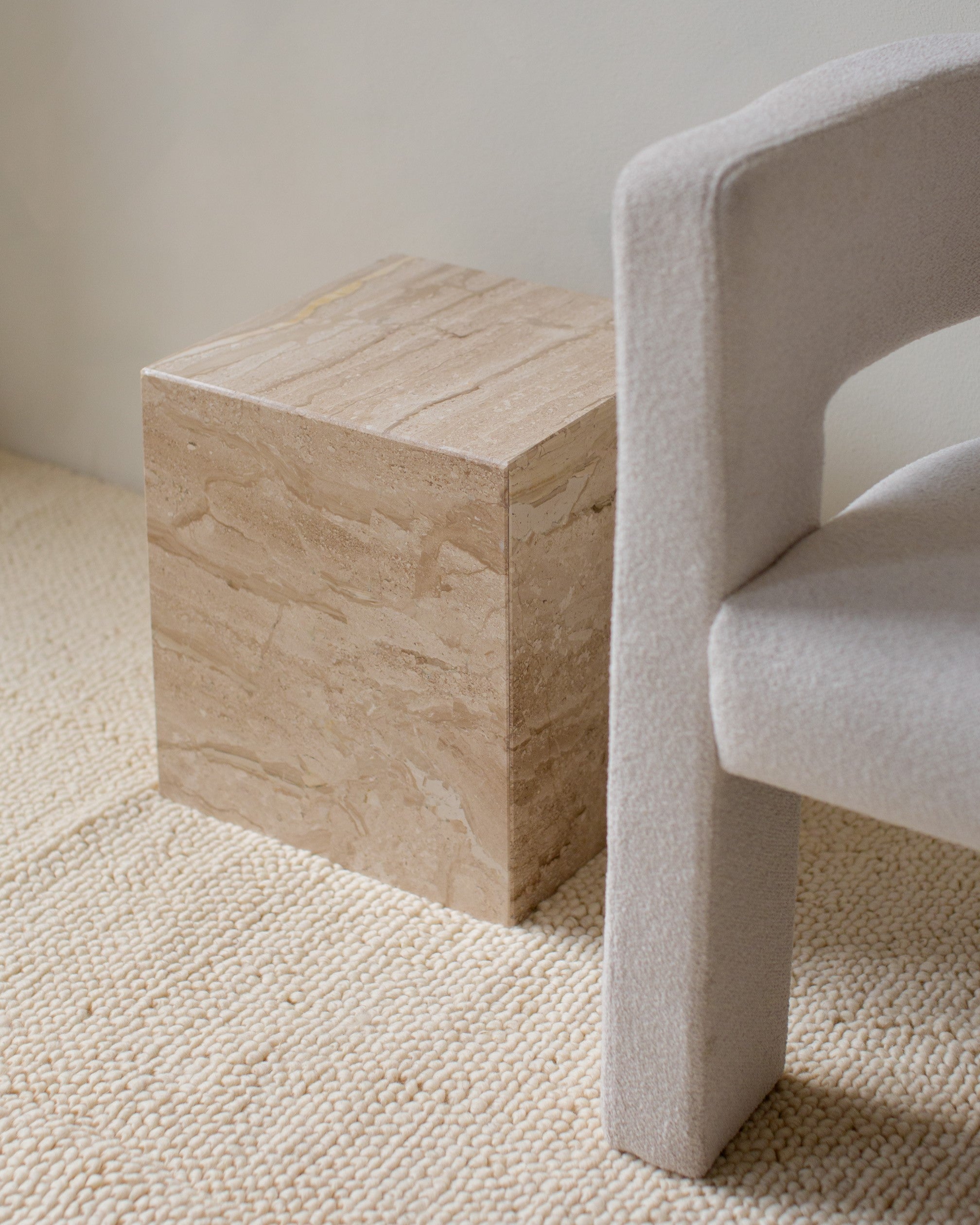 Mitsu side table in Diano Reale marble, minimalist square design beside chair