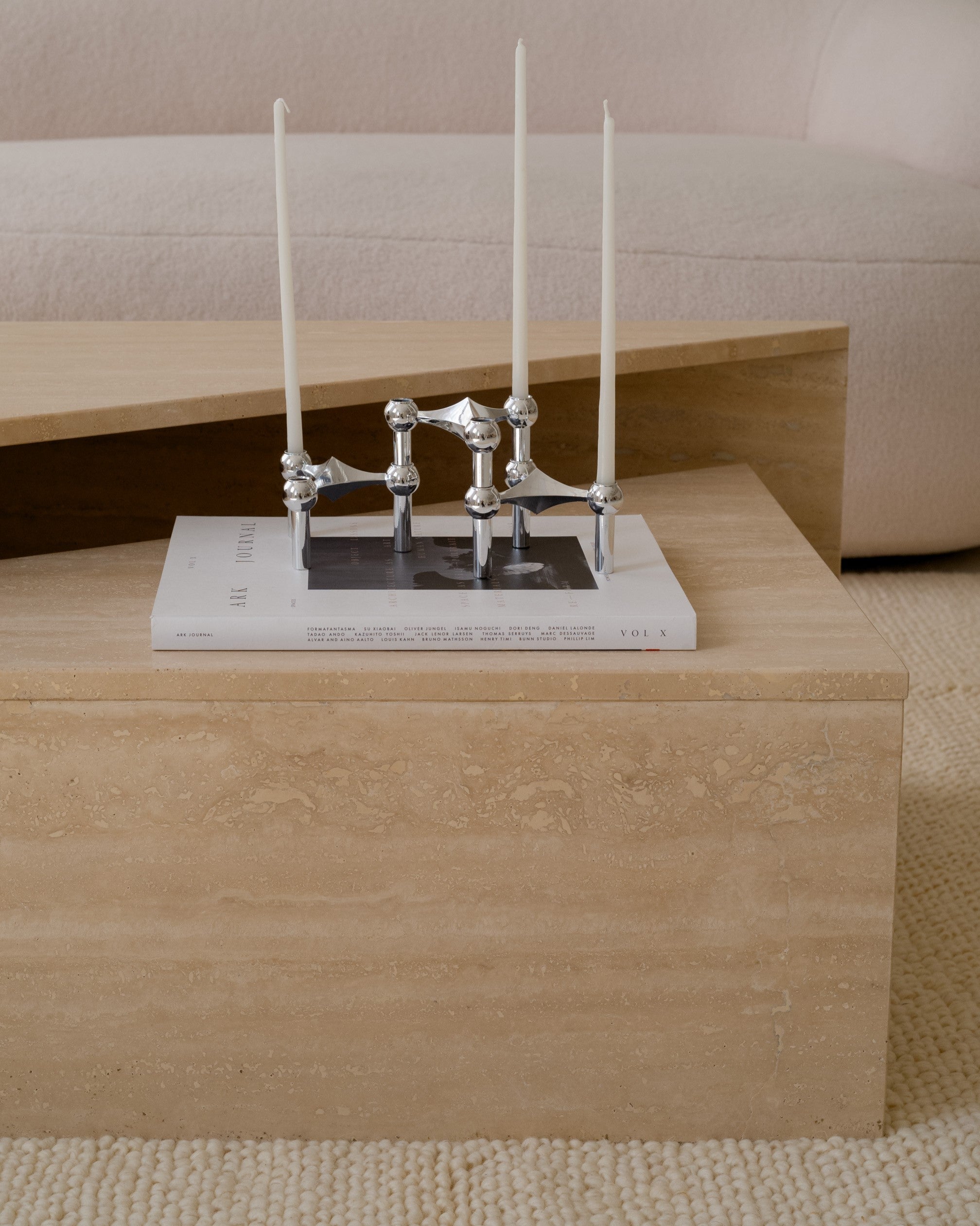 Travertine triangle side tables, polished stone surface and geometric form