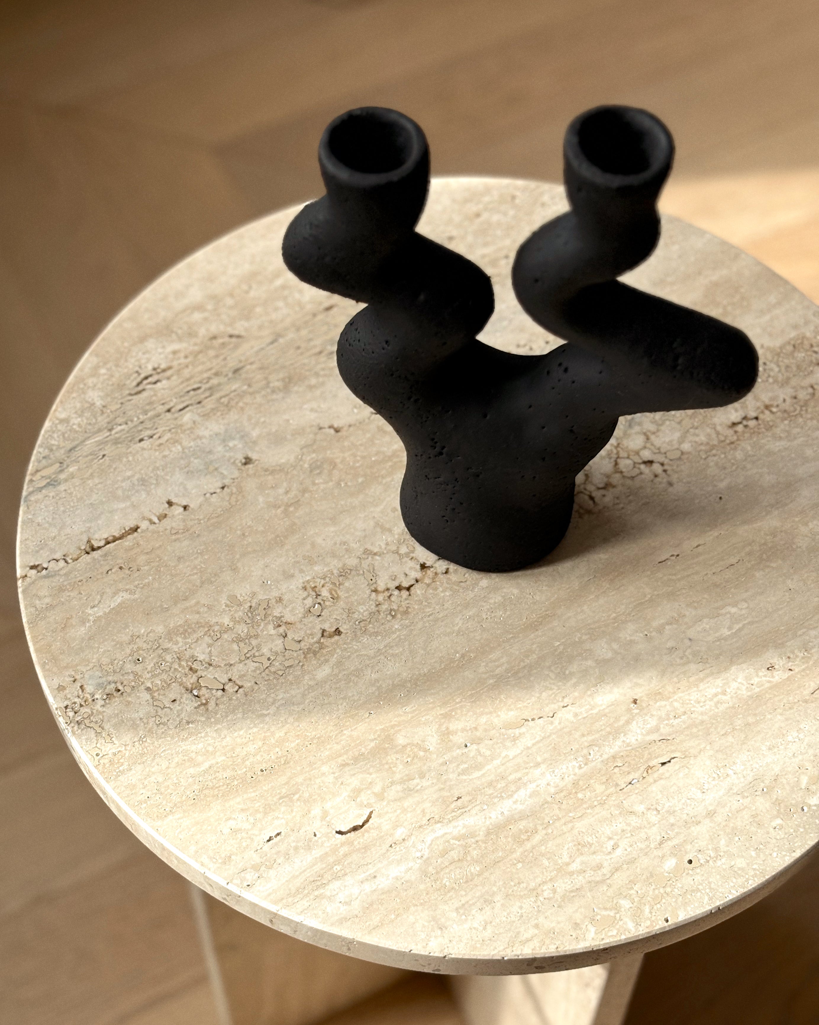 Sabi handmade black ceramic candle holder with sculptural wabi-sabi form on table