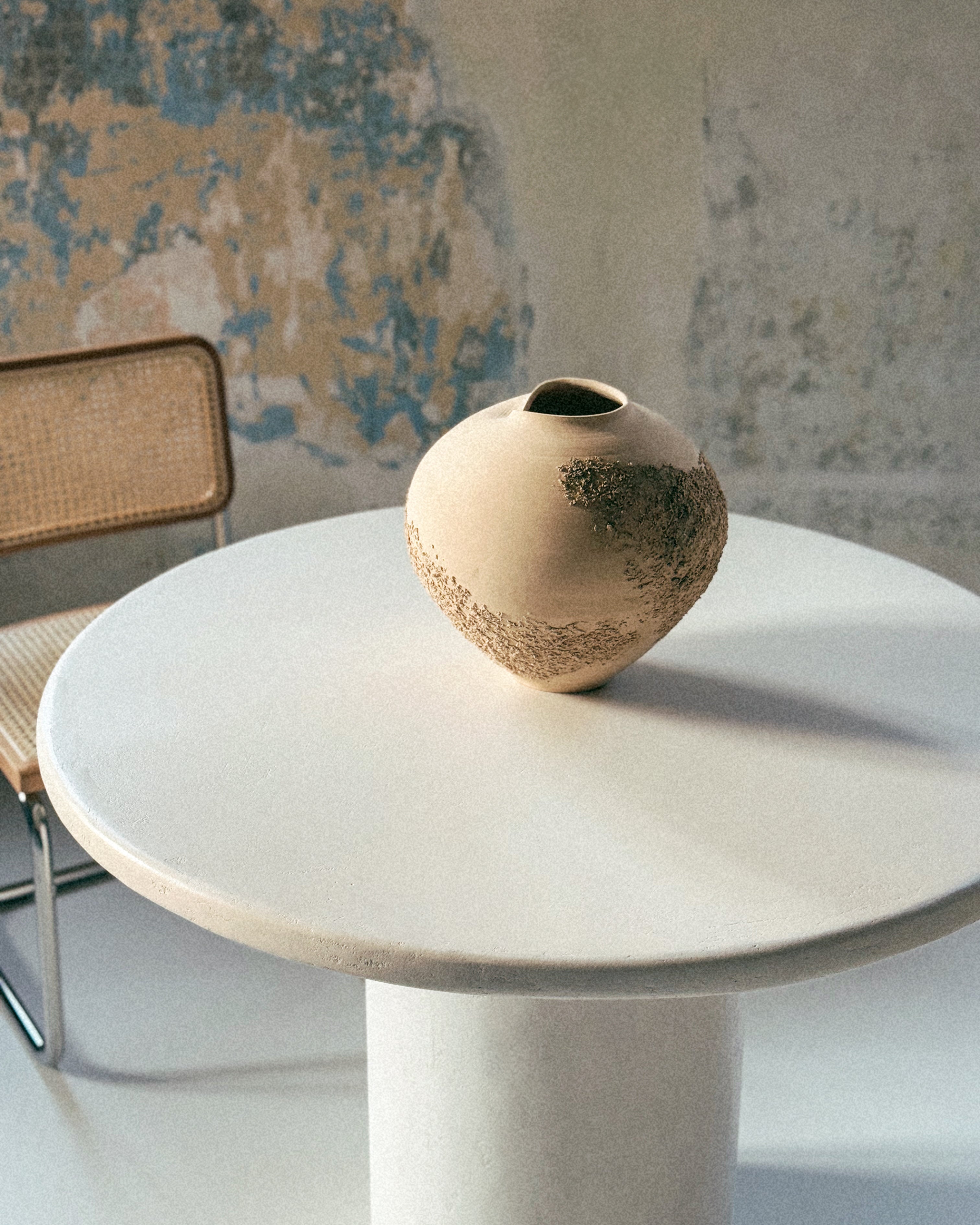 Sabi Vase no. 1, handmade heart-shaped ceramic vase on round table