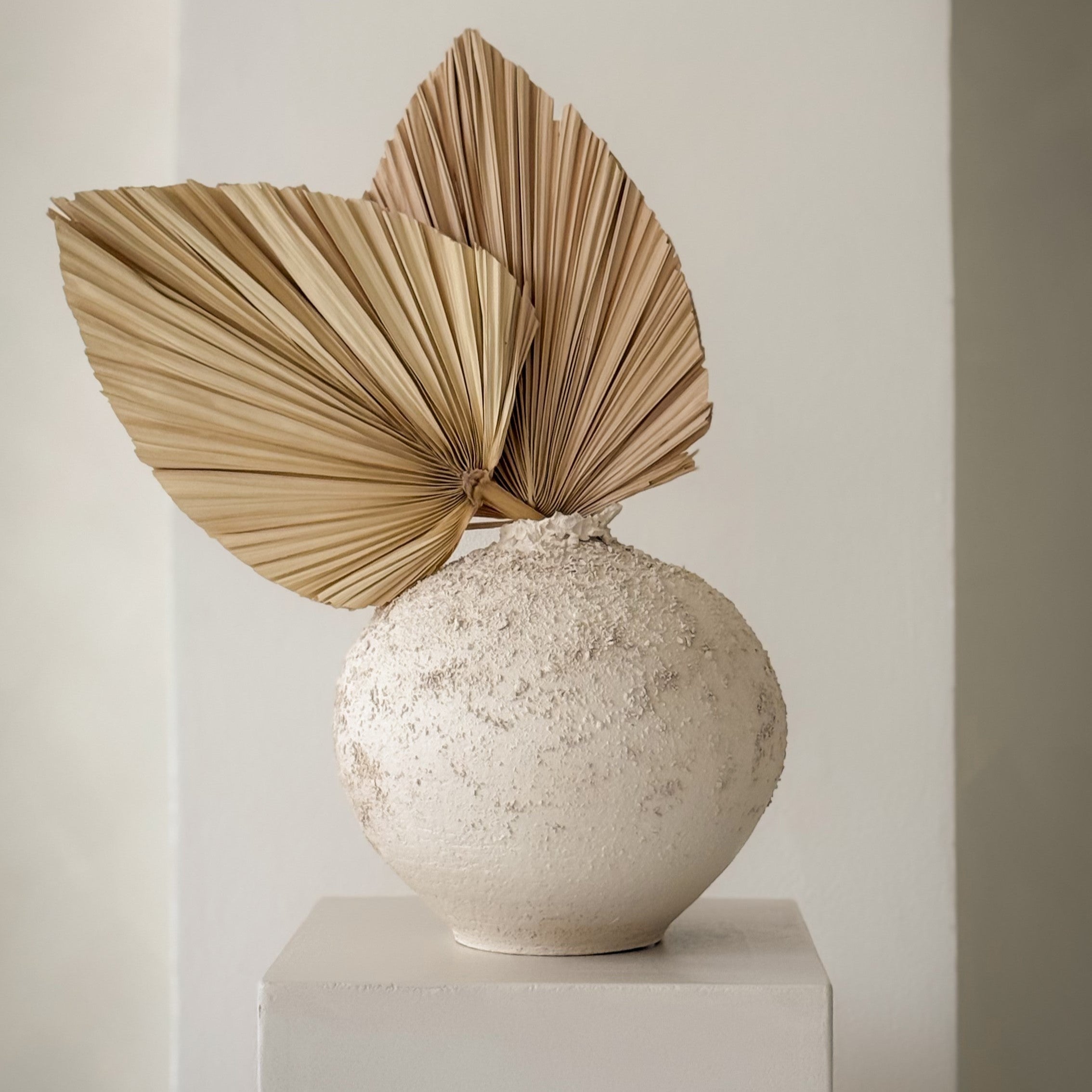 Sabi Vase no. 3, handmade white ceramic vase styled with large dried palm leaves