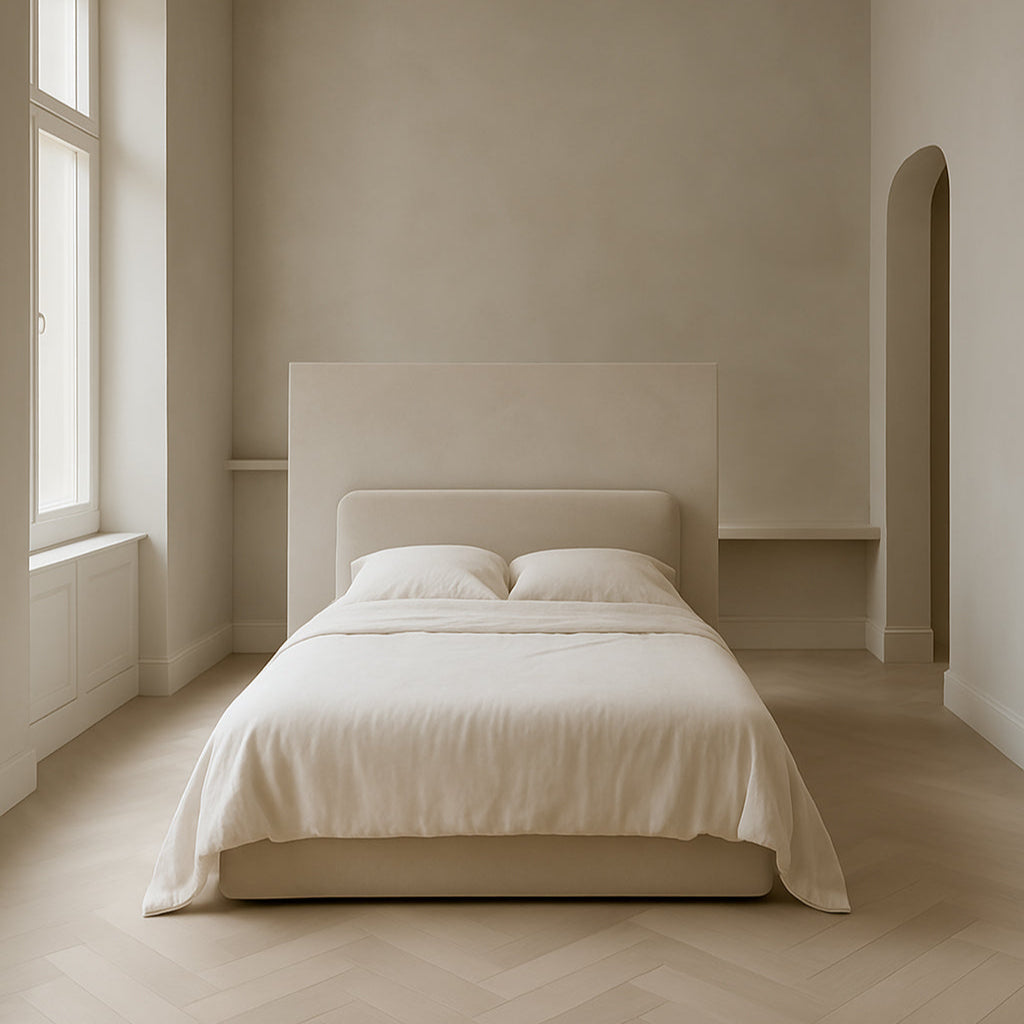 Serene bedroom with microcement walls and soft neutral tones, showcasing timeless minimalist design and natural textures.