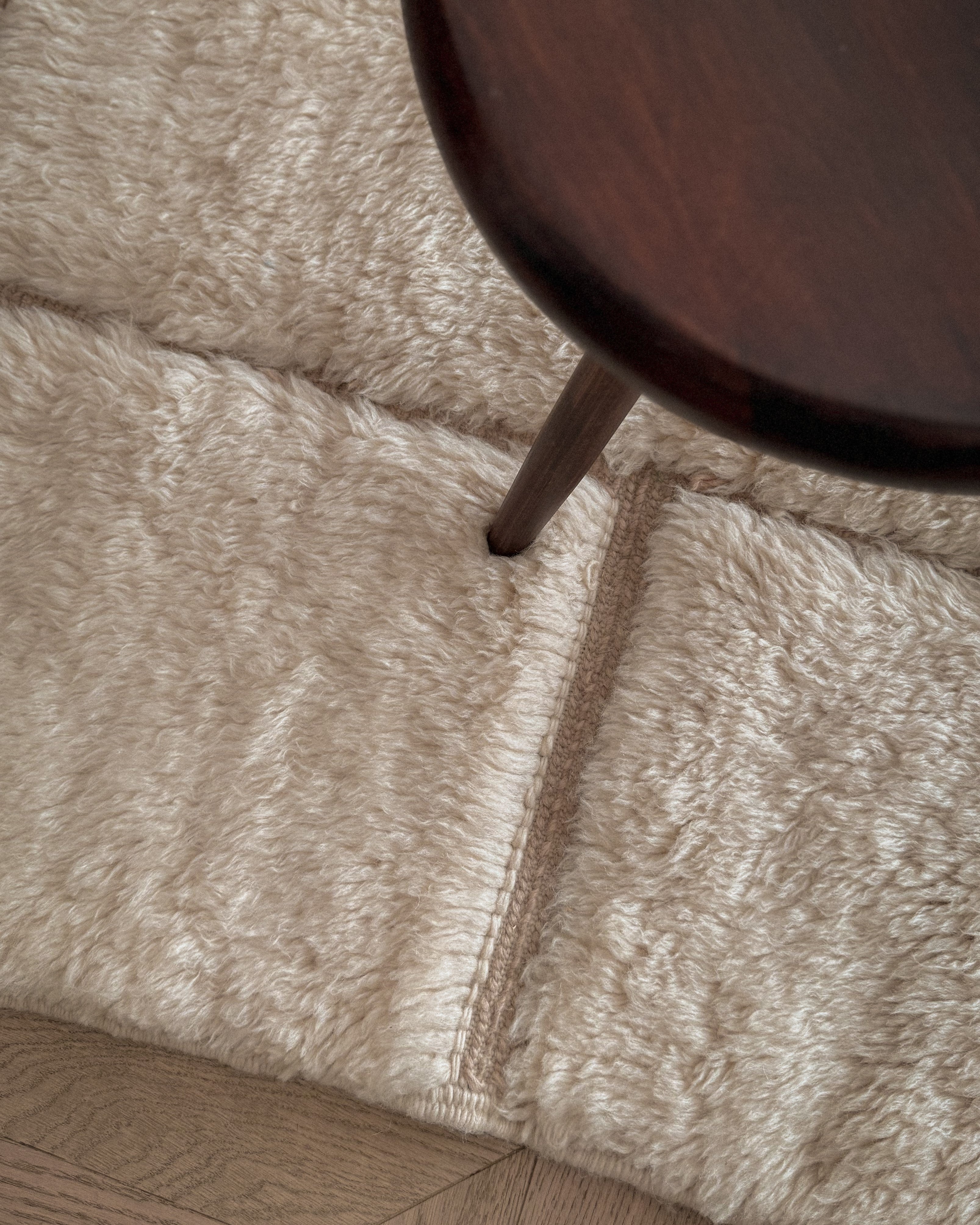 Moroccan Beni Mrirt wool rug No. 4 in modern living room setting with chair