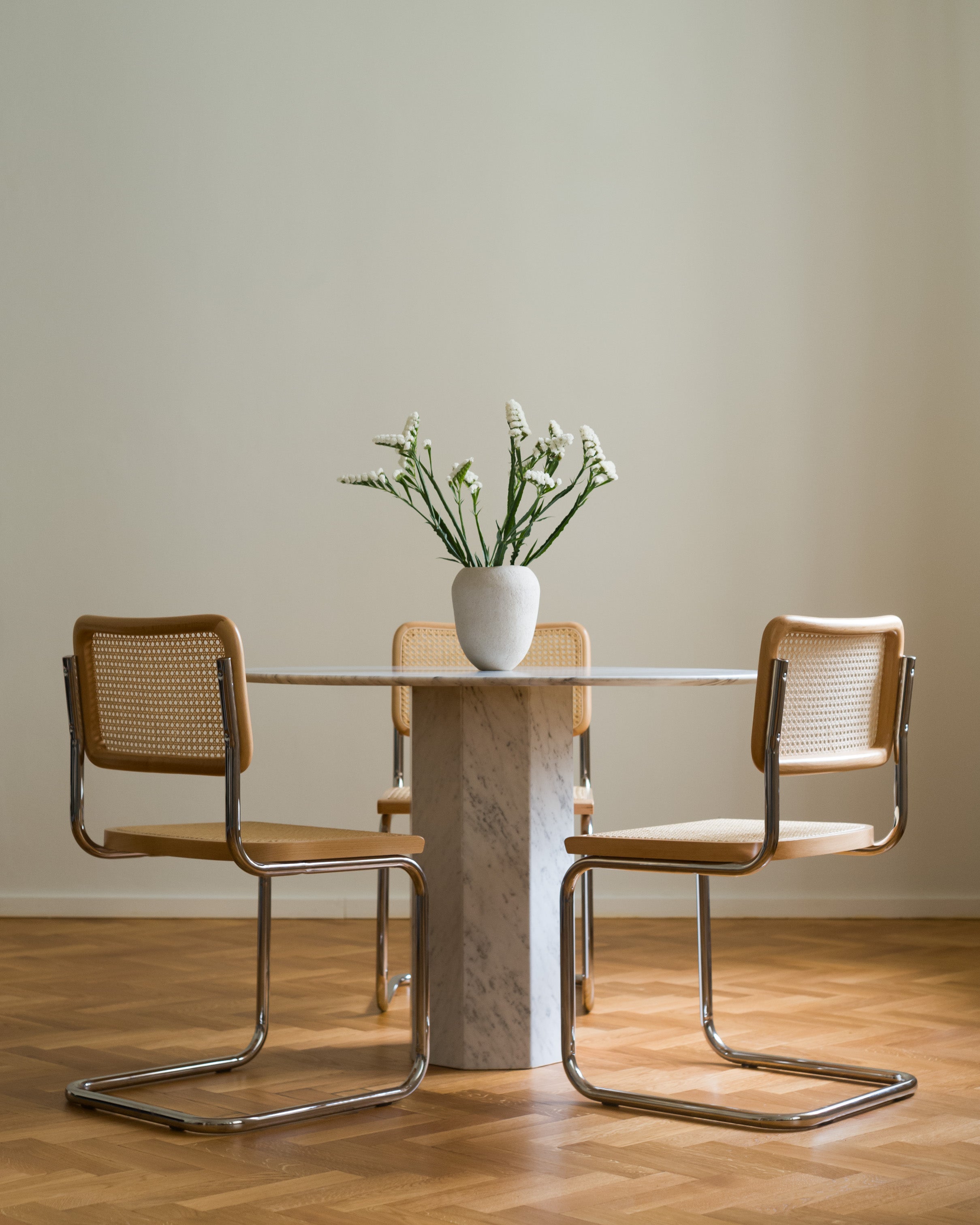 Cesca-inspired dining chairs arranged around a round table