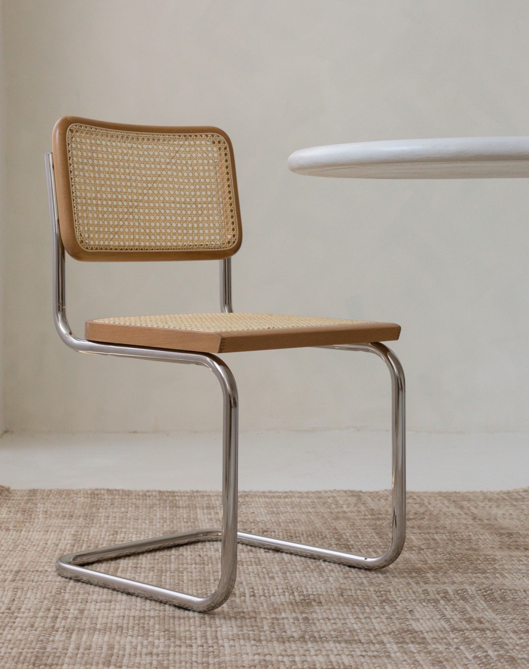 Single Cesca-inspired chair with chrome frame and rattan seat
