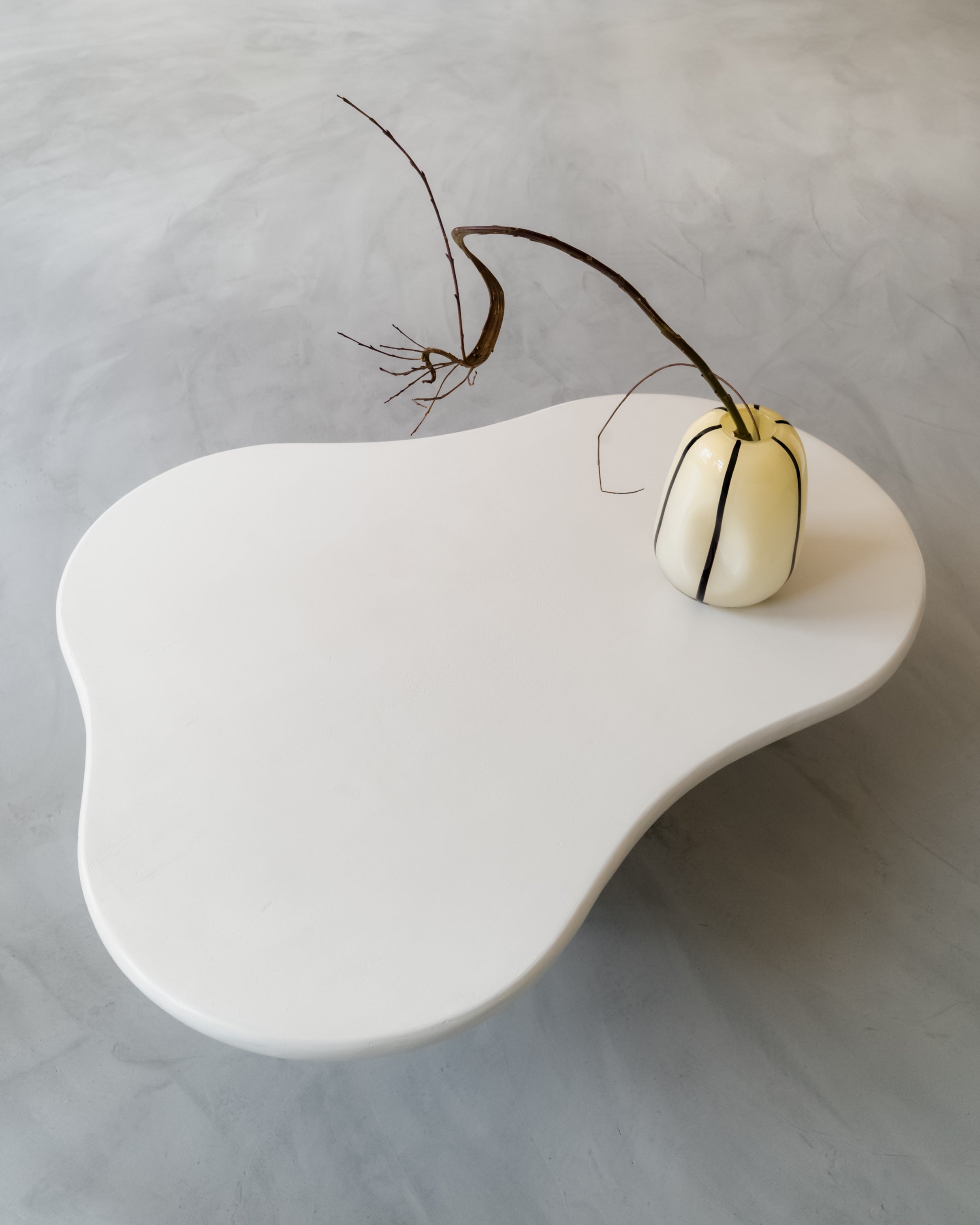 Close-up of Kanso Organic coffee table edge with small vase