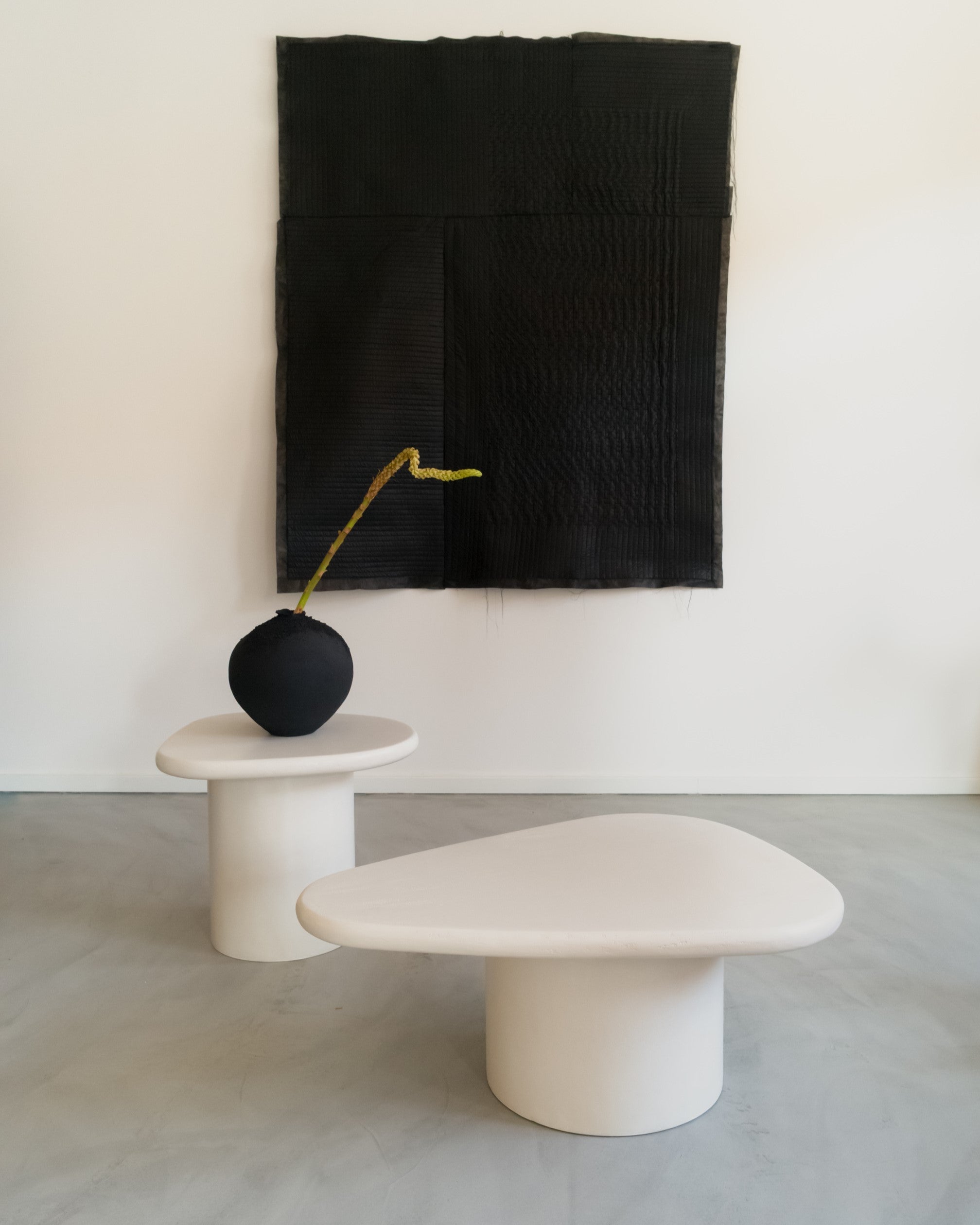 Organic coffee table set in microcement with sculptural, asymmetrical tops