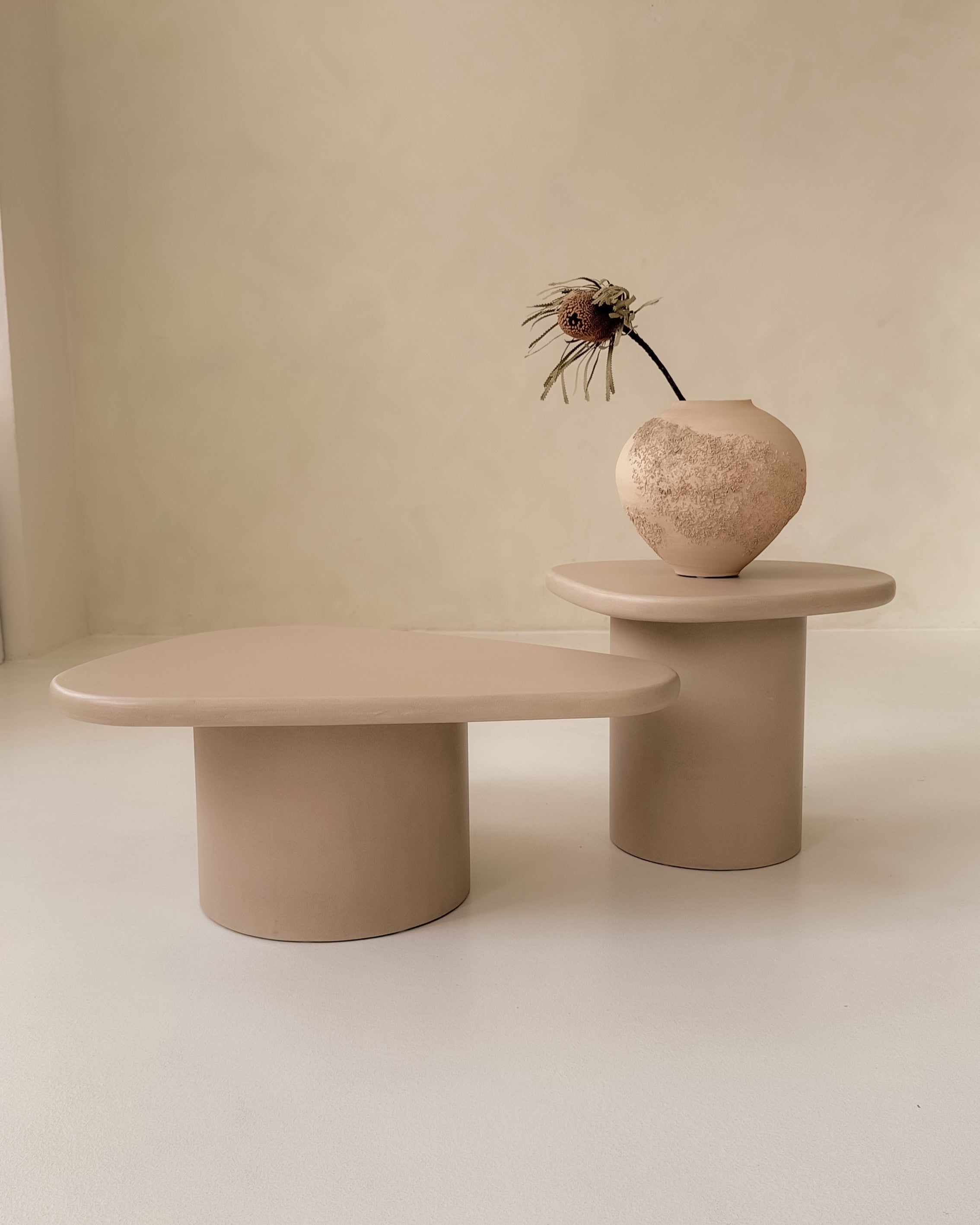 Pair of organic Kanso microcement coffee tables displayed together