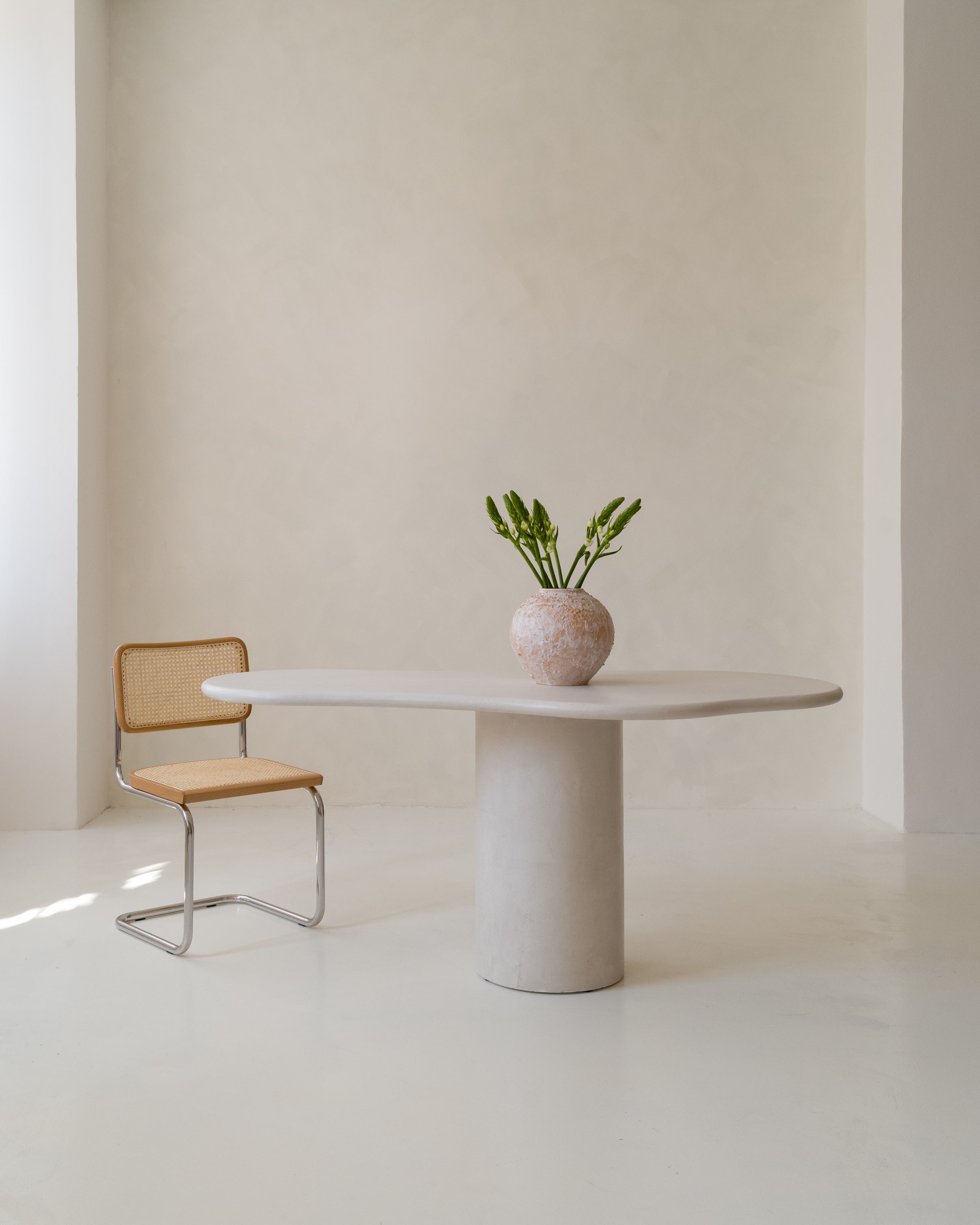 Minimalist setup with Kanso Organic dining table and single decorative vase
