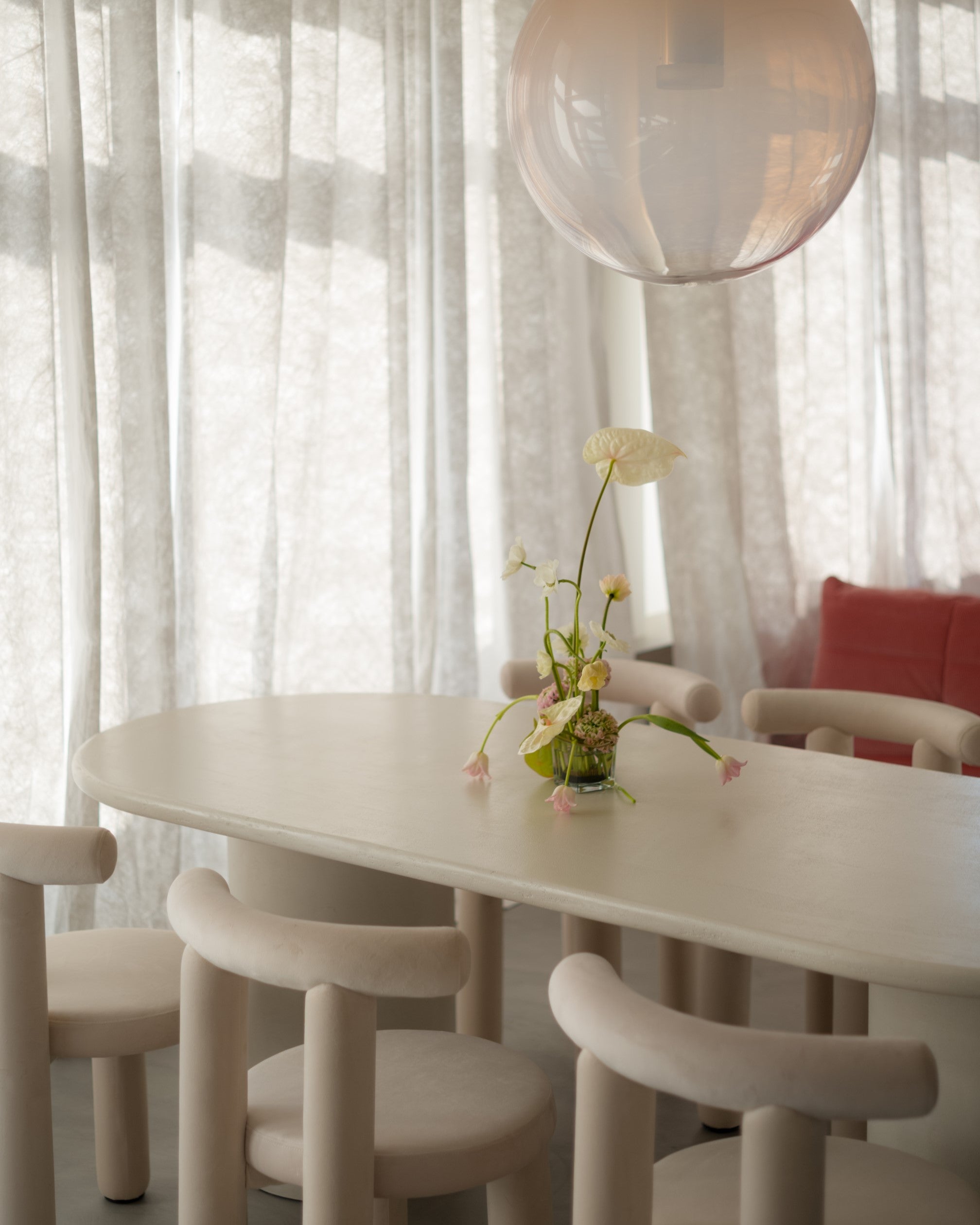 Kanso Oval dining table in microcement finish styled in dining room interior