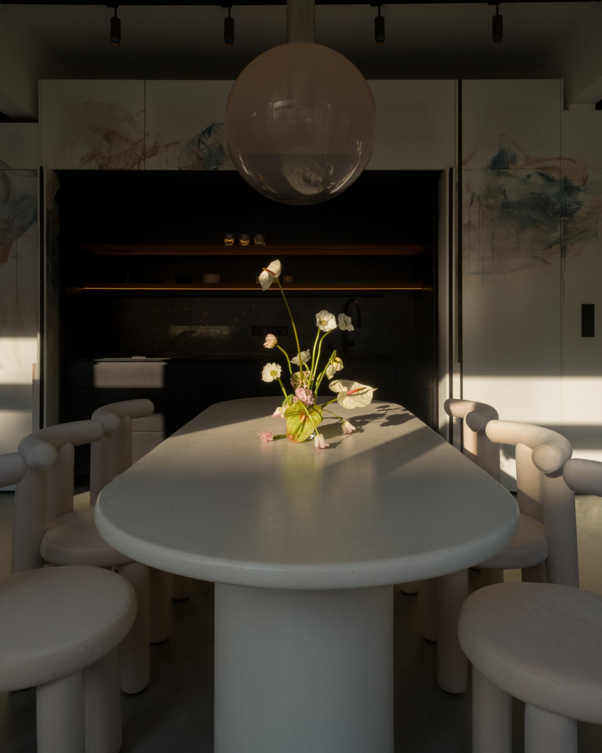 Side view of Kanso Oval microcement dining table with sculptural base