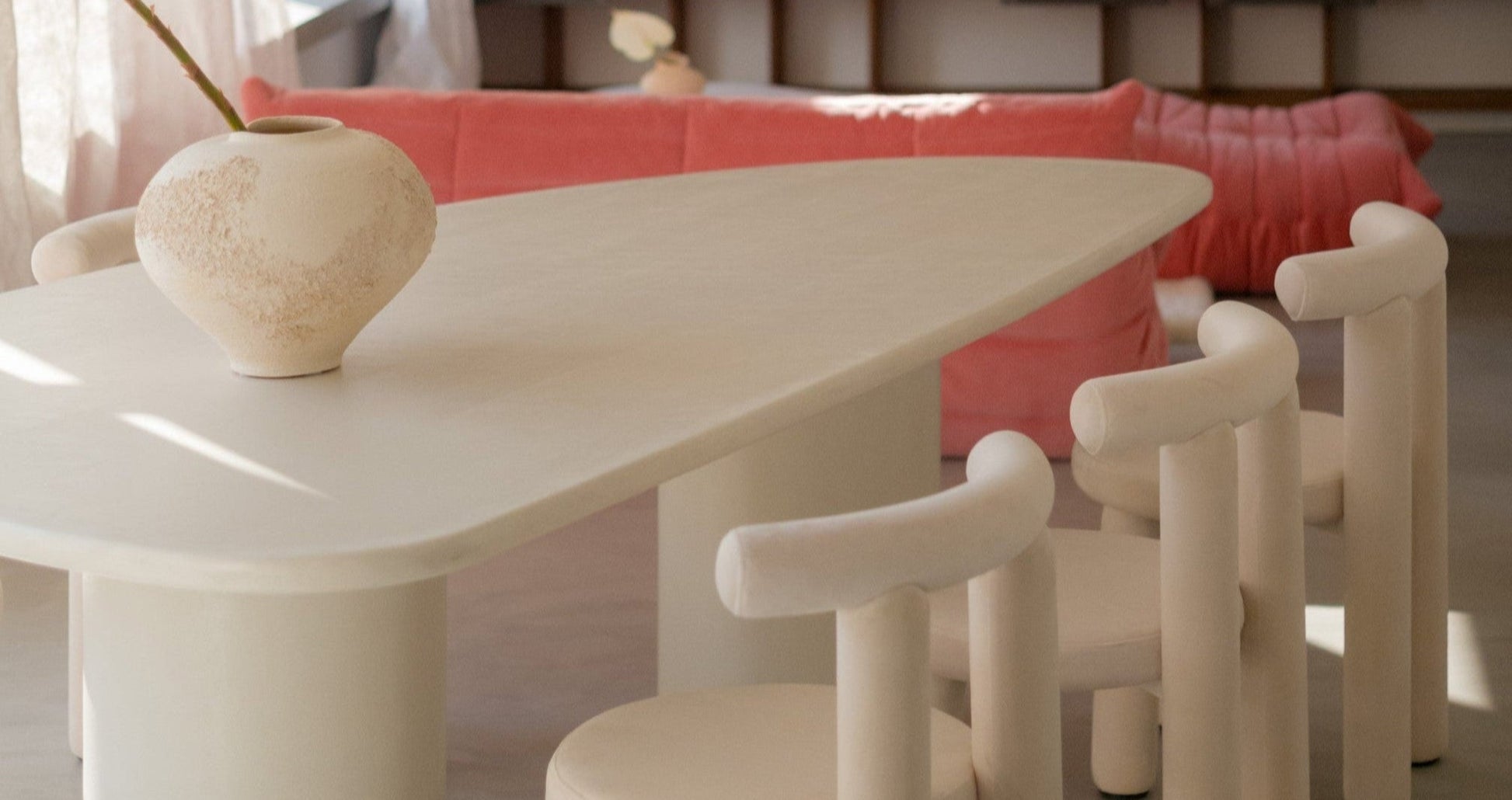 Side view of Kanso Wing dining table with soft sculptural shape
