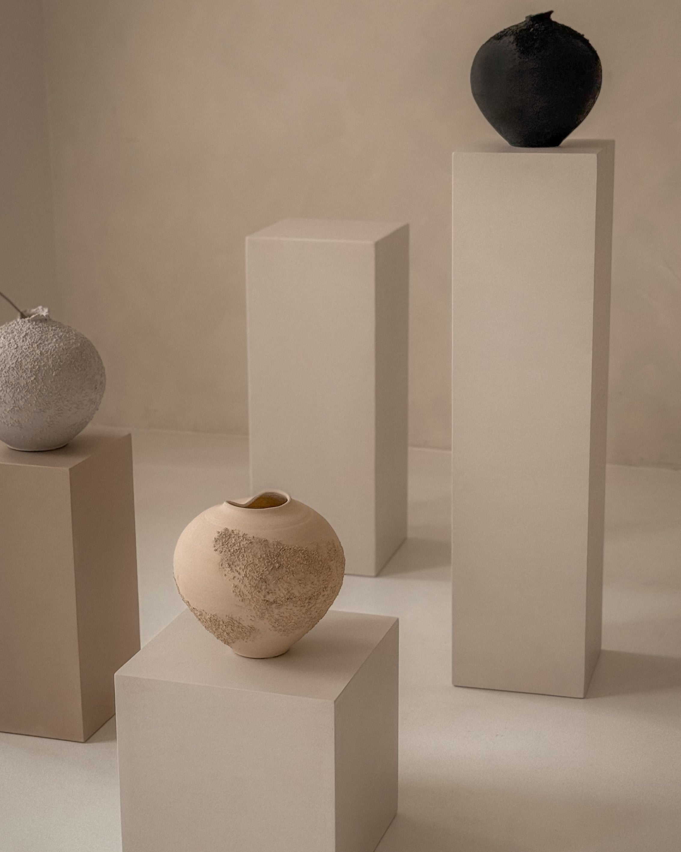 Handmade microcement pedestals, tall and low plinths with seamless finish