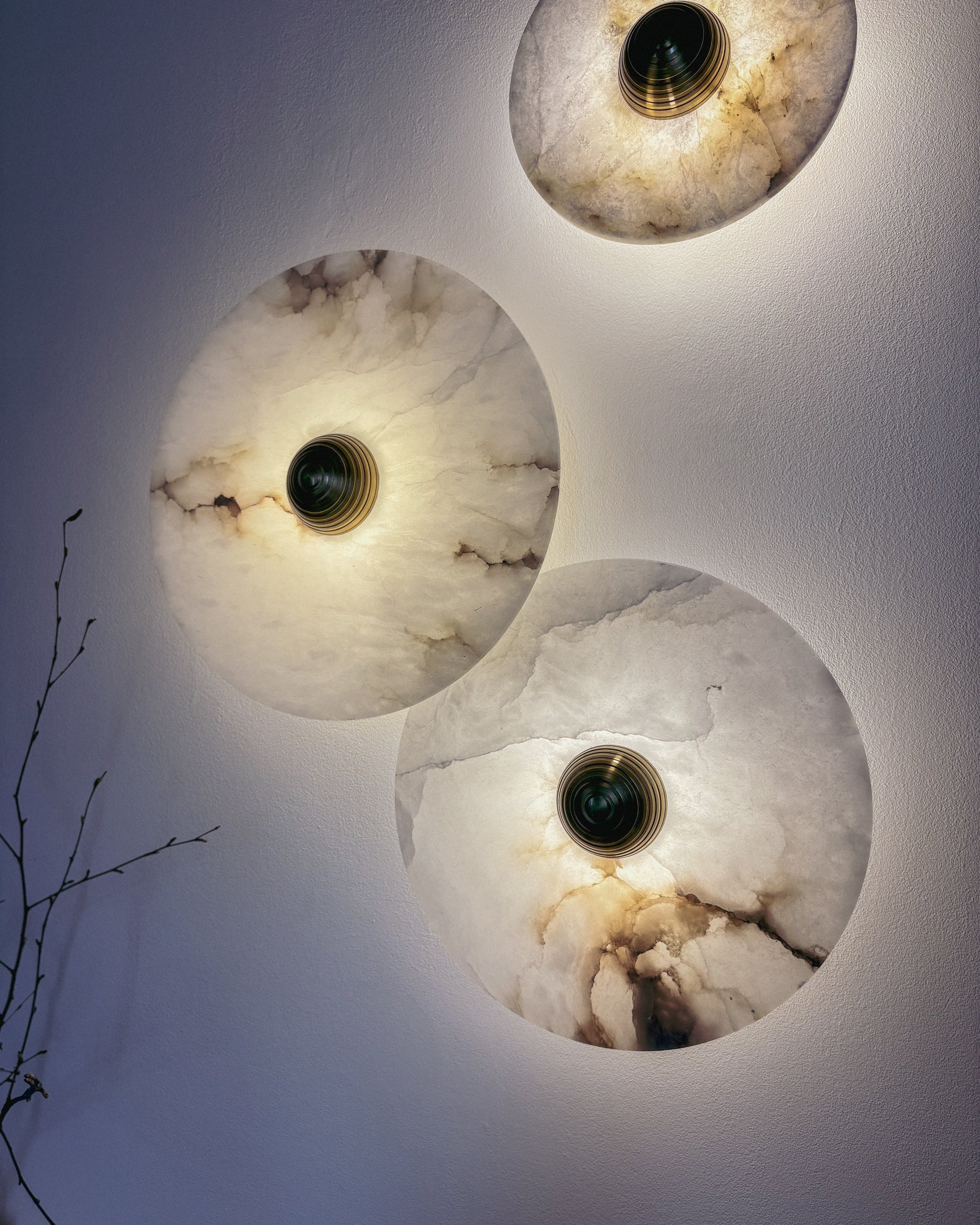Marble wall sconce with natural stone patterns, warm glow in dark interior