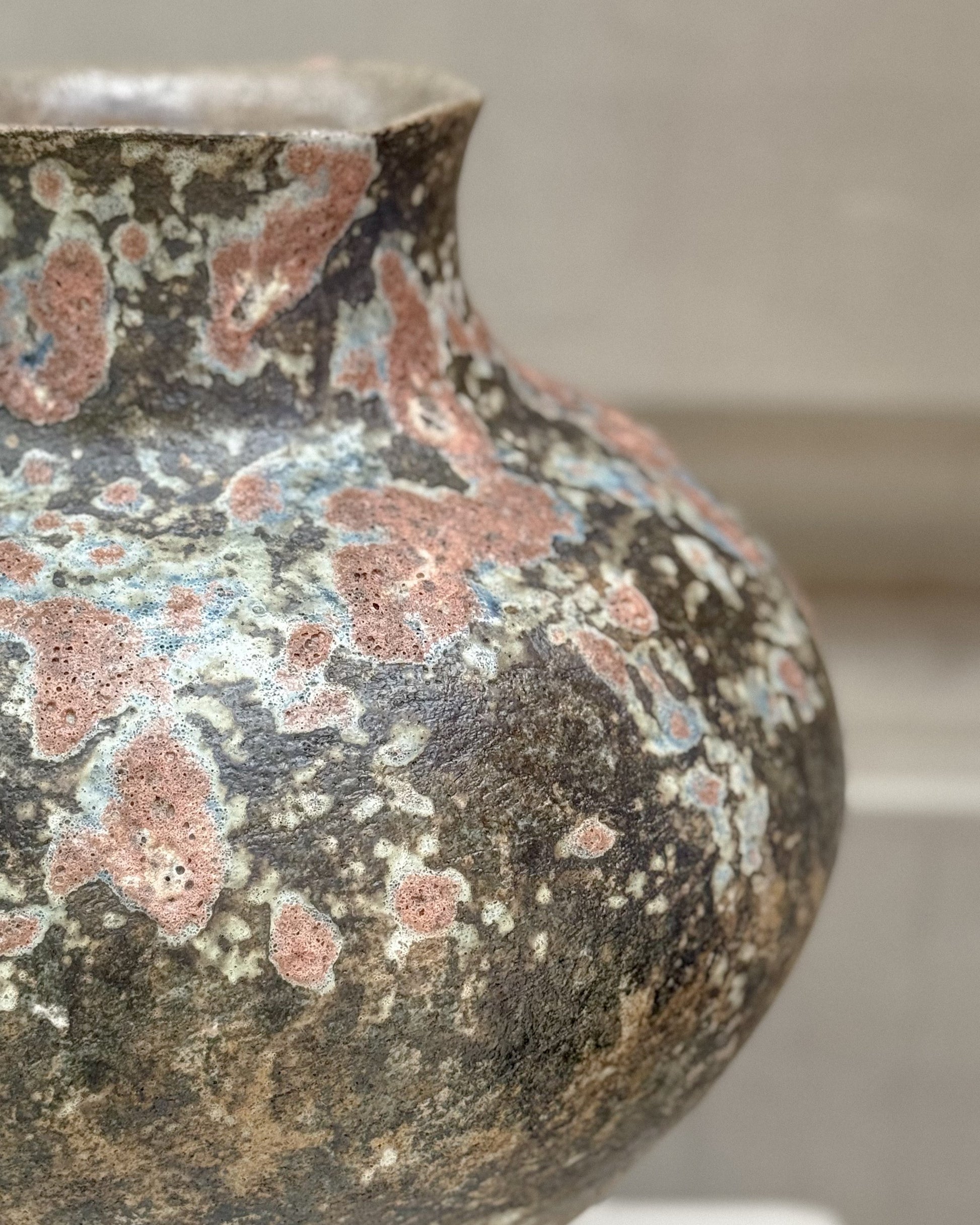 Detail of the handcrafted glaze, highlighting natural patterns and rich textures of the stoneware vase.