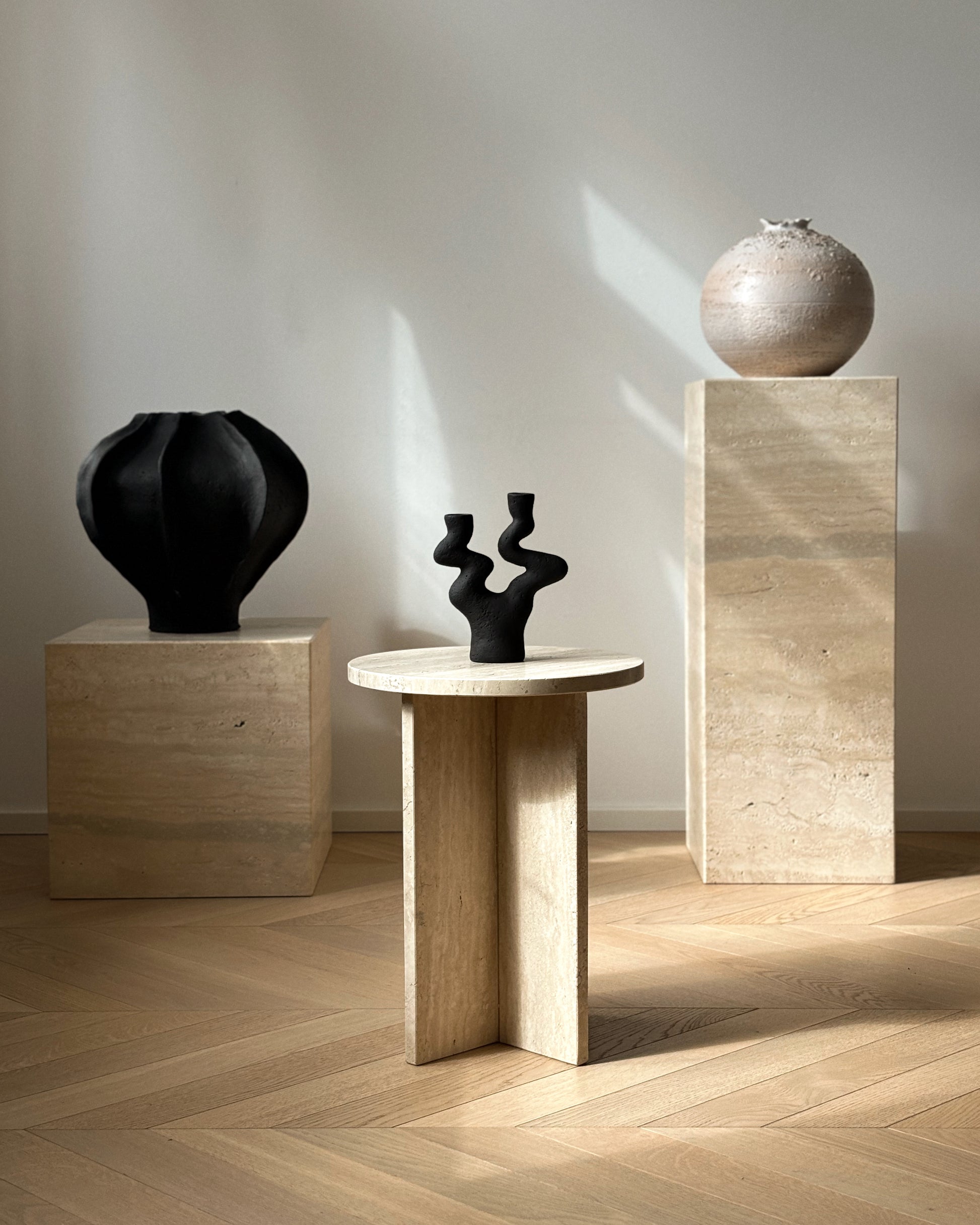 Sabi black ceramic vase styled in modern interior with candle holder and artwork